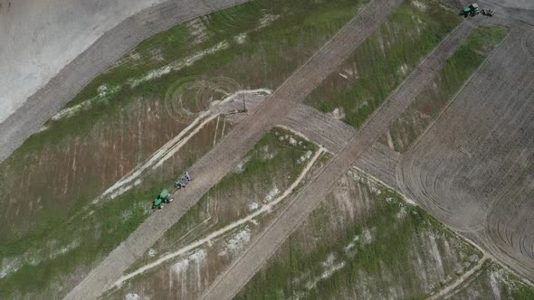 Tractor plowing a field in the Brazilian savannah to plant soybeans after deforestation - aerial vie