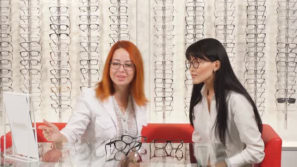 Positive Attractive Doctors Sitting on the Sofa Wearing New Glasses