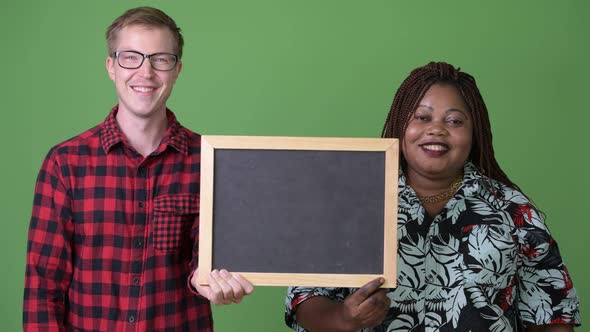 Overweight African Woman and Young Scandinavian Man Together Against Green Background