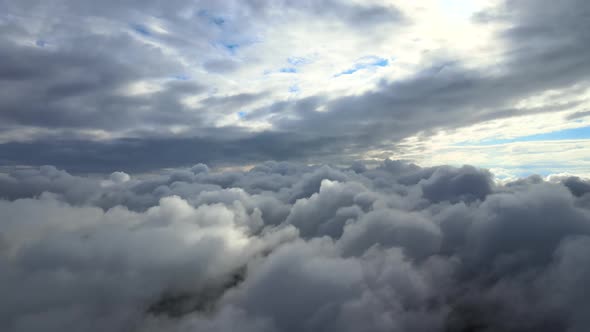 Aerial View From Airplane Window at High Altitude of Earth Covered with Puffy Cumulus Clouds Forming