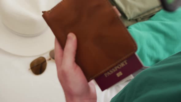 Albino african american man holding smartphone with covid 19 vaccine passport