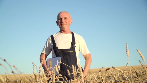 Portrait Shot of the Cheerful Caucasian Senior Man Farmer Smiling To the Camera. Farming and