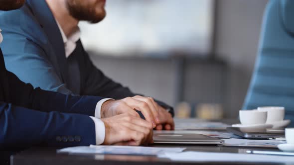 Portrait of young businessman person using a computer laptop notebook in technology device in office