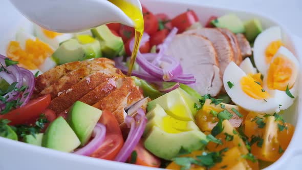 American cobb salad with chicken, avocado, egg, tomatoes and onions