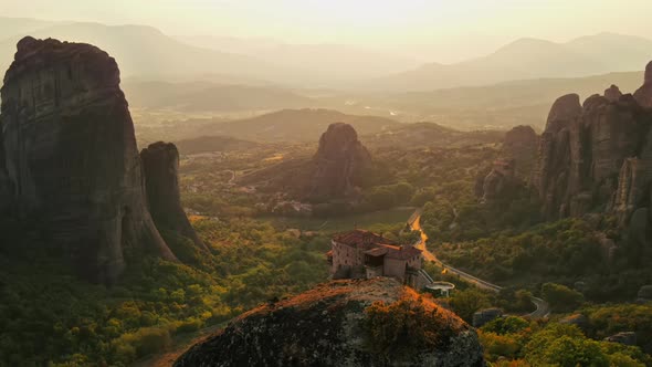 Aerial drone view of the Meteora in Greece at sunset. Rock formations with Orthodox monasteries