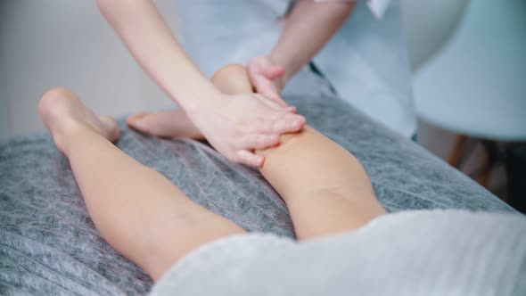 Massage - Massage Therapist Is Kneading the Legs of Her Client