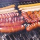 Brats Being Cooked on a Grill with Flame and Smoke - VideoHive Item for Sale