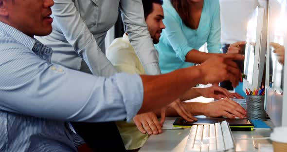 Business executives working over computer