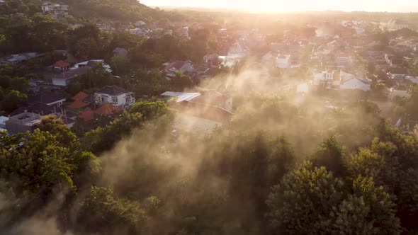 Drone Flying in the Smoke Over the City Sunset