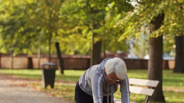 Senior Caucasian Woman Stretching in Public Park