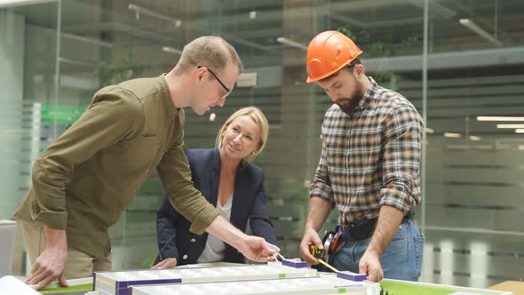 Team of Caucasian Architect Working on House Model Scale Planning Building Project