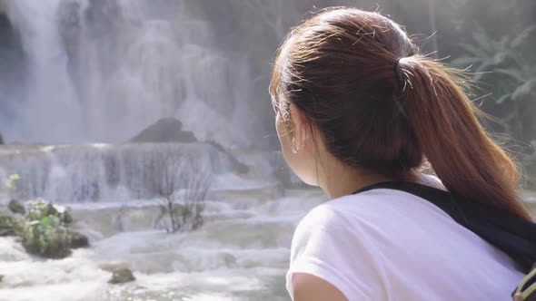 Tourist Woman Looking At Waterfall