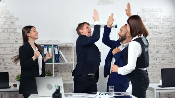 Happy Business People Celebrating Successful Deal Dancing Clapping Hand Having Fun at Modern Office