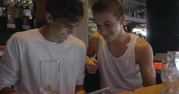 Two teenagers with pad in cafeteria