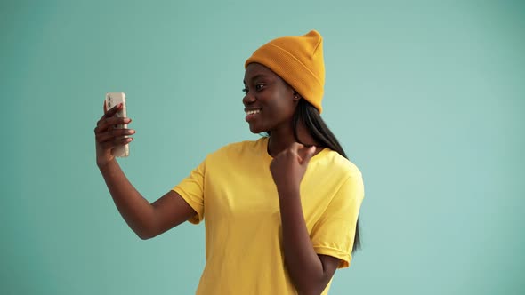 Pretty African woman making selfie photo by phone