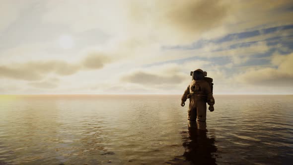 Spaceman in the Sea Under Clouds at Sunset