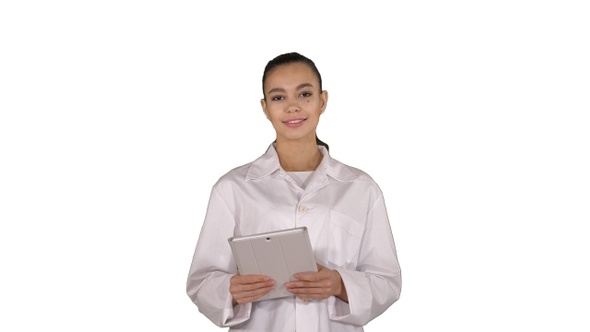 Happy female doctor using tablet computer swiping pages