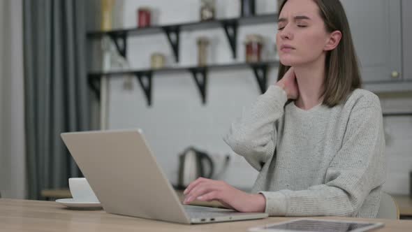 Beautiful Young Woman Working on Laptop and Having Neck Pain