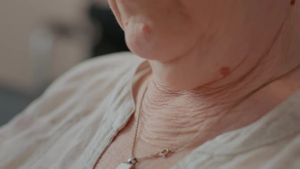 Elder Woman with Wrinkled and Loose Skin on Neck
