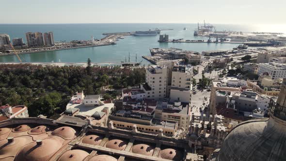 Drone pass close by the distinctive clock tower of Malaga Cathedral; Spain