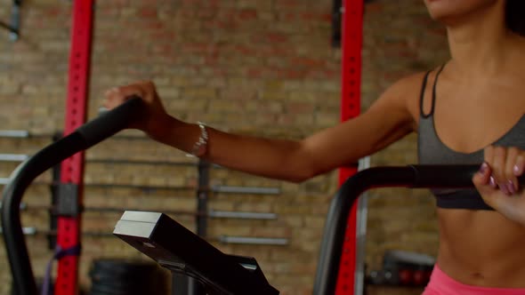 Closeup of Female Hands on Exercise Bike Handlebar During Workout