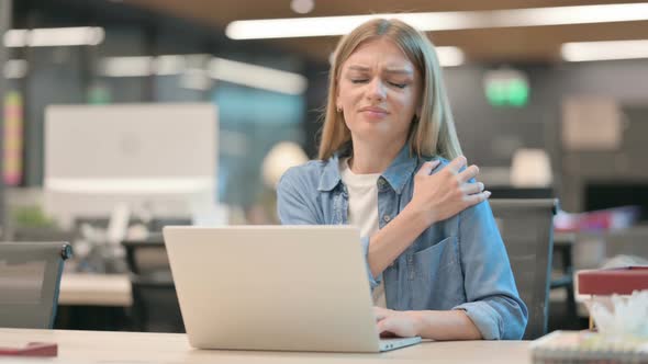 Young Woman Having Neck Pain While Typing on Laptop