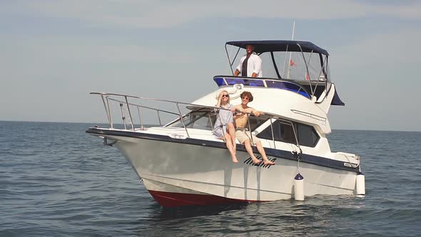 Young Couple Relaxing on a Yacht. Rear View of Relaxing People on Sailboat