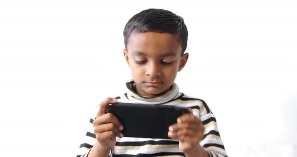 one Pakistani kid game playing on the mobile phone