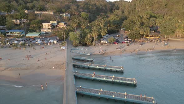 Travelers enjoying vacation on sandy beach on seashore