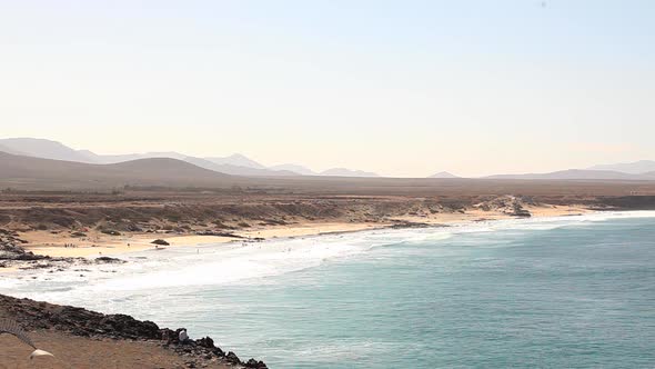 Seaside view with sandy beach and ocean waves in Fuerteventura