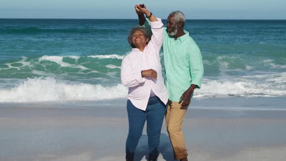 Senior couple dancing at the beach