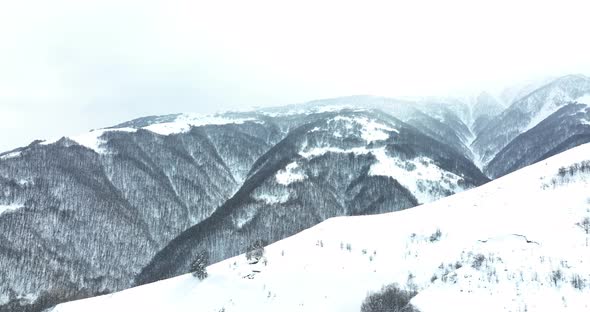 Aerial view of beautiful snowy mountains in Pasanauri, Georgia