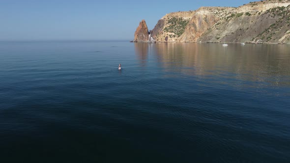 Aerial View From Above on Calm Azure Sea and Volcanic Rocky Shores