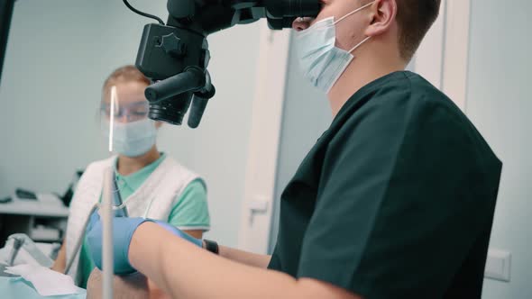 Dentist Using Microscope