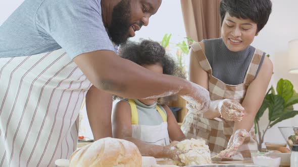 African American family with daughter thresh flour for cooking with father and mother together.