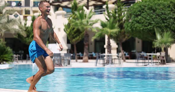 Happy Joyful Sports Man Jumping Into Pool