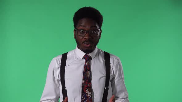 Portrait of Young African American Man Looking at Camera with a Wow Surprised and Enthusiastic