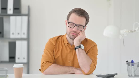 Young Man Sleeping in Office