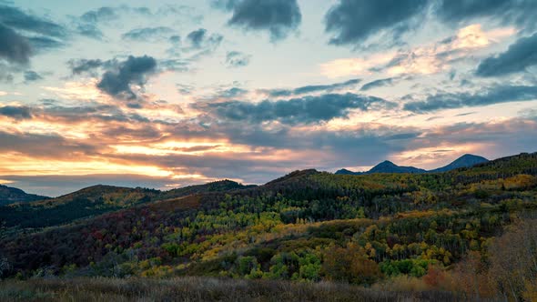 Sunset over mountain layers of Fall colors