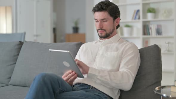 Man Using Tablet at Home