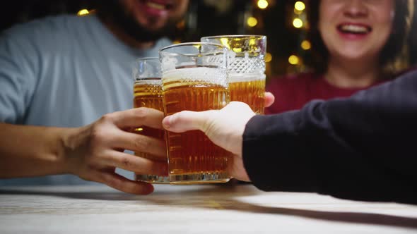 Close Up Shot of Friends Drinking Beer and Talking with Each Other in Bar