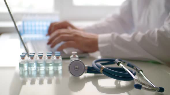 Doctor Works in Front of a Laptop Monitor