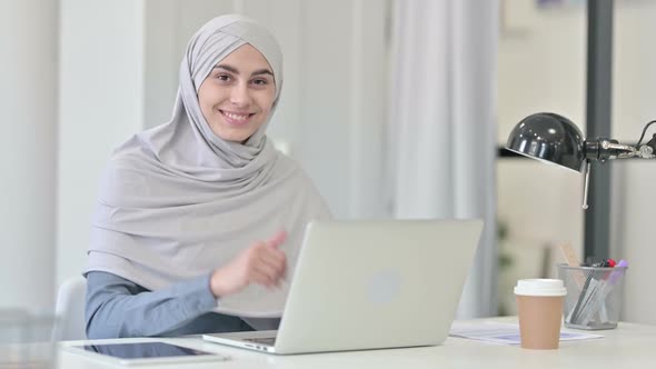 Young Arab Woman with Laptop Showing Thumbs Up