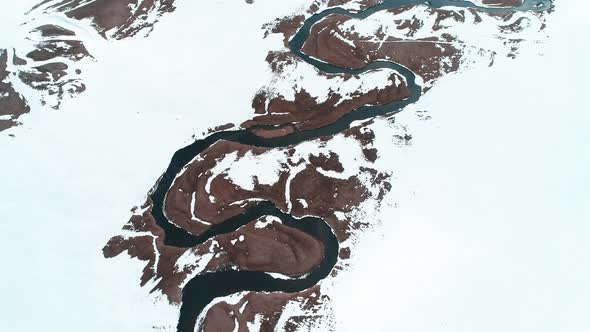 Aerial View of Winter River Flowing 