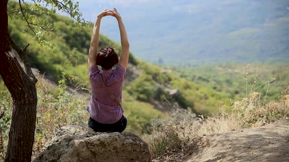 Young Woman Is Sitting on Stone in Ghost Valley. Beautiful Summer Landscape. Demerdgi Mountains