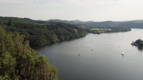 Boats Sail on a Lake Surrounded By Nature and Mountains.