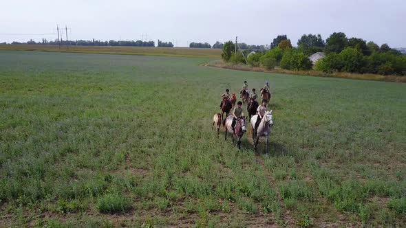 Group Of Horseback Riders. Group of young horseback riders riding in countryside