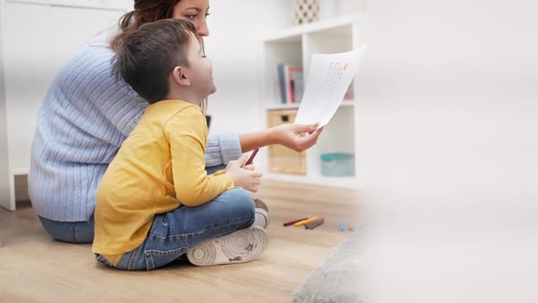 Child Therapist Helping Kid to Understand Family Problem Using Drawing Picture of His Parents