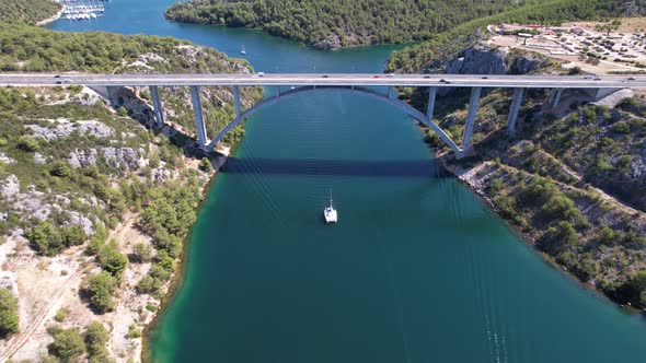 Flying over Krka river, autostrada and arch bridge at summer in Croatia, Europe