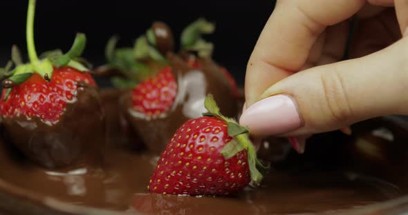 Hand Dipping Strawberry in Melted Chocolate. Fresh Berries Sweet Dessert Food